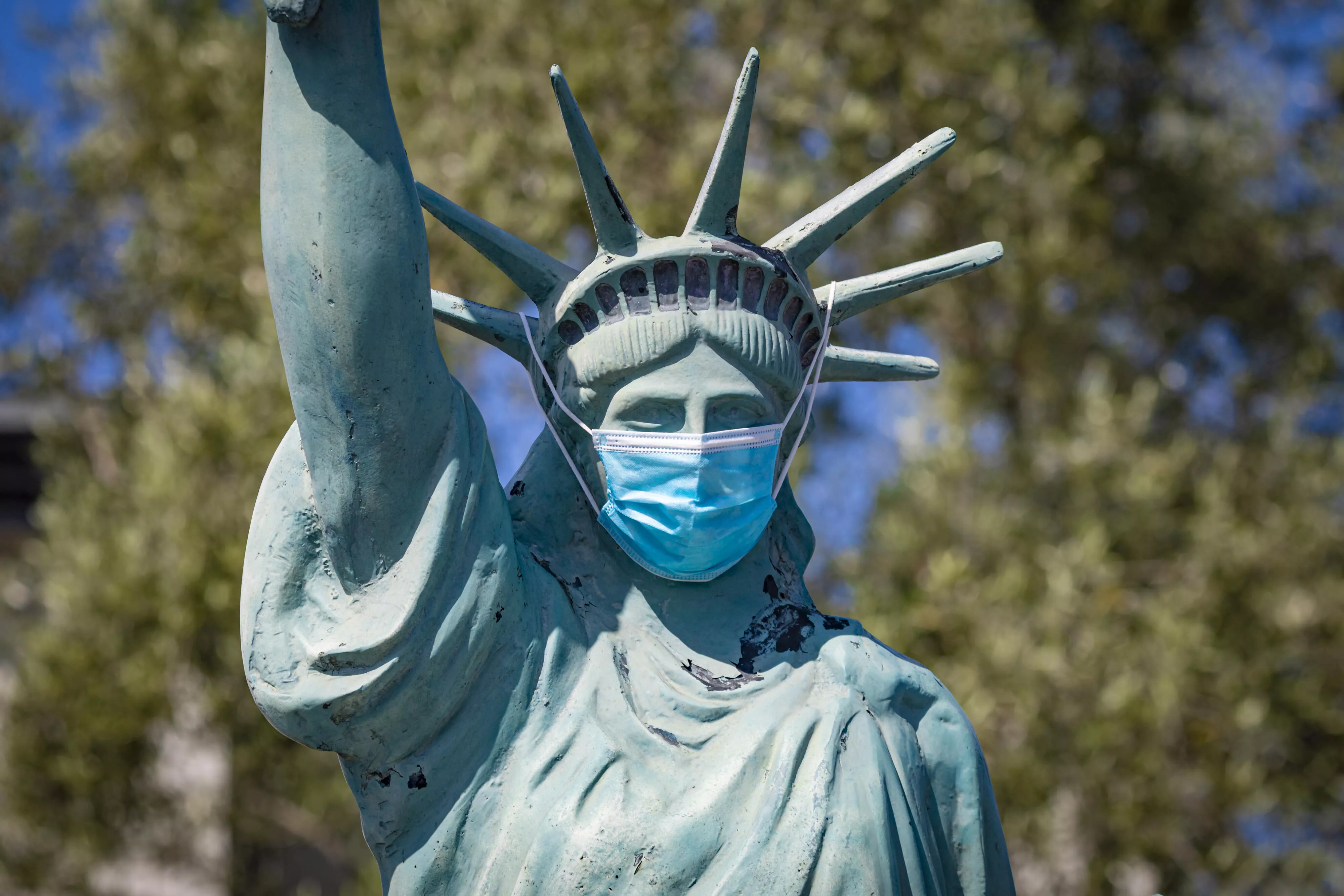 Statue of Liberty wearing a face mask to protect from Coronavirus